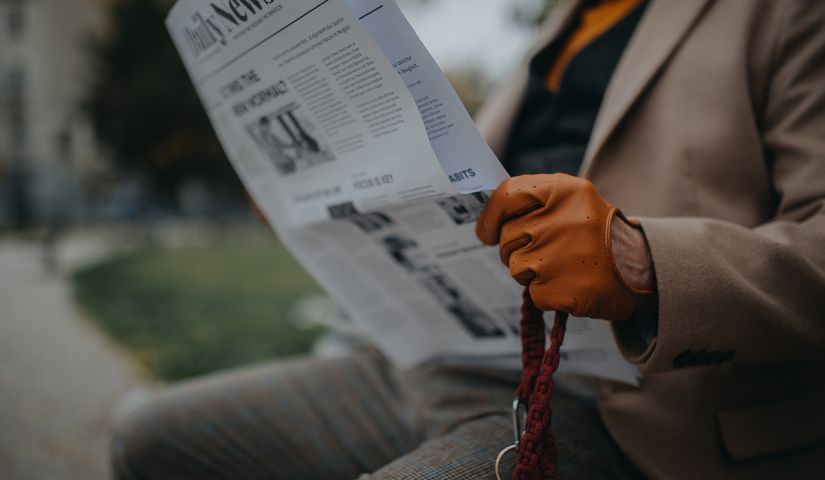 senior-man-sitting-on-bench-and-reading-newspaper-2024-10-21-10-07-43-utc.jpg